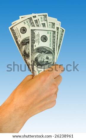 finances. money in hand on blue background