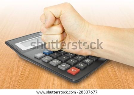 business concept. men aggression. fist with electronic calculator