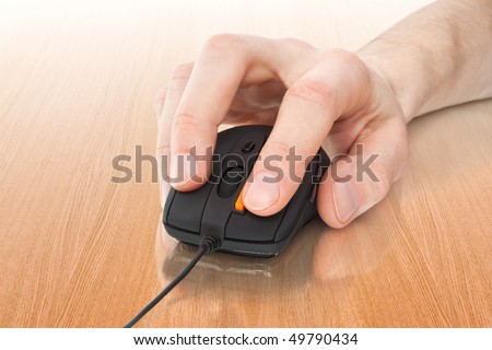 black computer mouse with hand over table