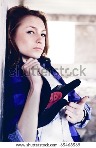 Girl portrait with broken old music record in the grunge room