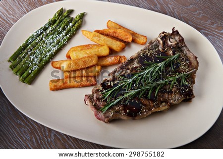 Grilled beefsteak with french fries and asparagus