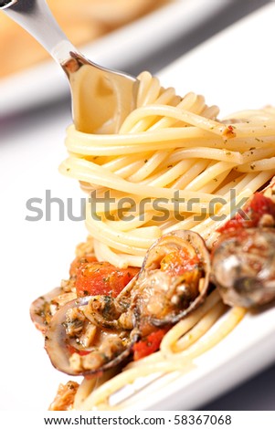 fork with the spaghetti with seafood on a plate