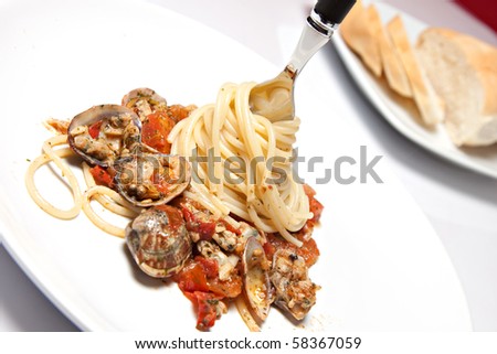 fork with the spaghetti with seafood on a plate