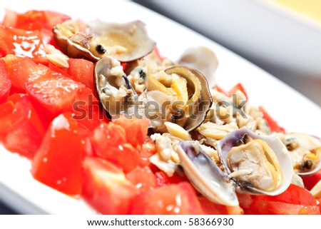 sauce with fresh tomatoes and clams on a plate