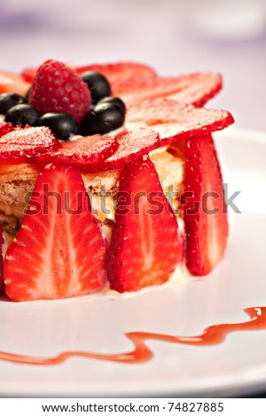 Cake with strawberries, blueberries and raspberries