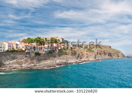 Azure sea and blue sky above the reef houses on the Mediterranean coast
