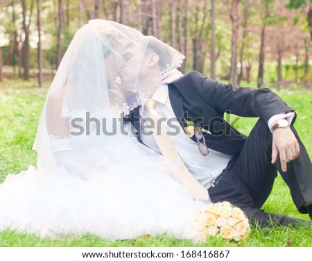 Happy young husband and wife are kissing