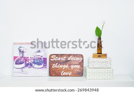 Bicycle - flower bed on picture and flower in the bottle and Motivating grunge wooden poster quote Start doing things you love