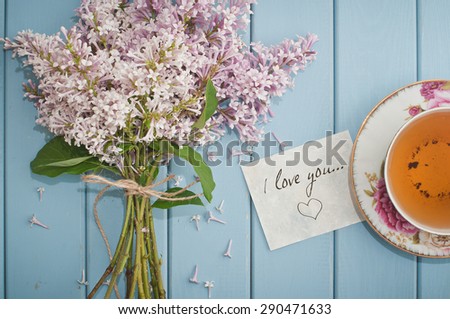 card i love you , summer bouquet of beautiful blooming lilac and english black tea in china teacup with saucer