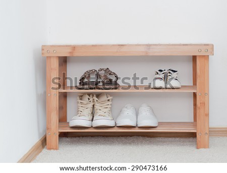 Old vintage wooden bench with shoes shelf, storage of shoes on the shelf