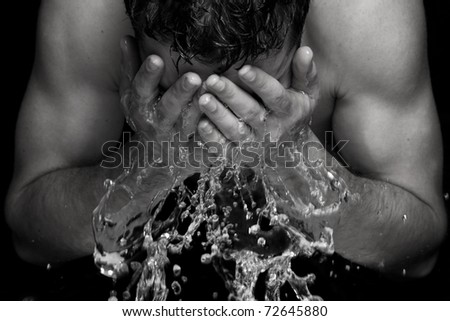 Strong athletic young man washing up