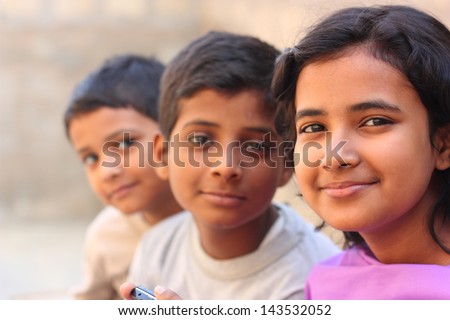 Pakistani siblings making pose and smile