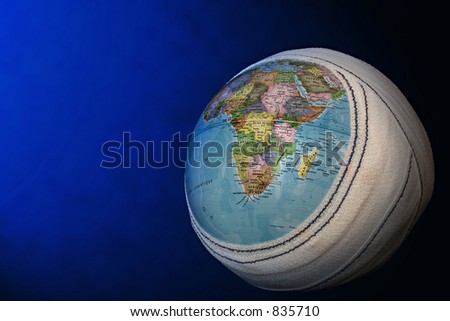 Globe with bandage on a blue background.