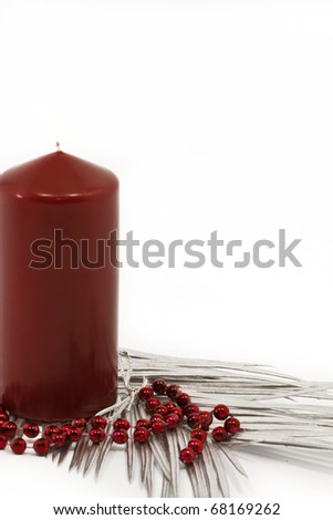 Red candle and silver leaves as a Christmas decoration