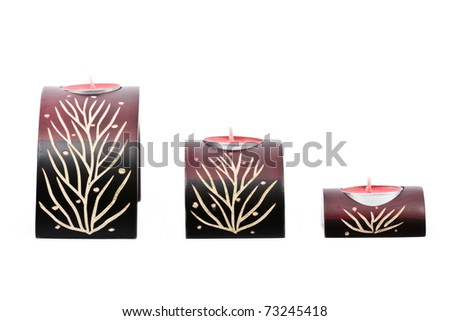 Ornamental decorated candle holders with small candles isolated