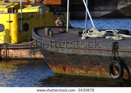 detail of an old & rusty cargo ship in harbour
