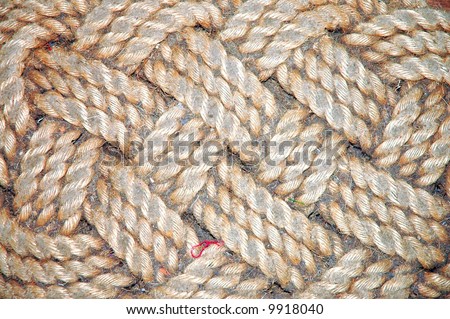 old braided dirty door-mat closeup detail background