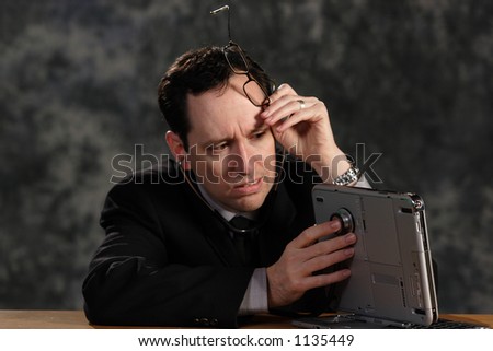 photo of a businessman checking for signs of life from his computer