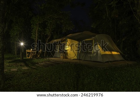 Big tent at night with lantern and lamp