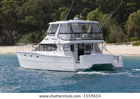 A power yact pulls up to Moreton Island in Queensland Australia, off the coast of Brisbane