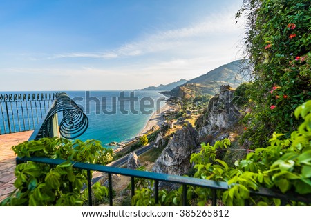 Amazing sunny mediterranean coast viewed from beautiful wrought iron balcony in Sicily, Italy