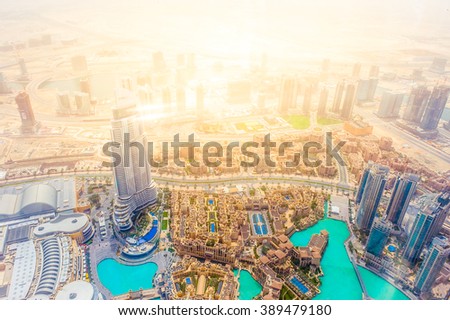 Birds eye view urban landscape from Burj with shining lights of the downtown business central area of the city of gold, Dubai, UAE