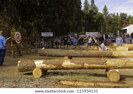 WEST POINT, CA - OCTOBER 6: Unidentified male & female competitors in the axe throwing event at the Lumberjack day, on October 6, 2012 in West Point. West Point celebrates it\'s 38th Lumberjack day.