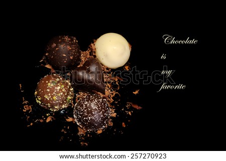 Low Key lighting on Chocolates sitting on a reflective black background and space for your text - Chocolates are my favorite