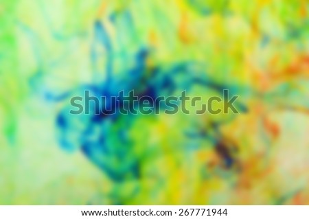 deliberately blurred colored dye in a water as a psychedelic background