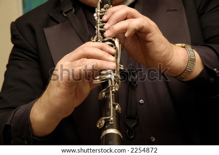 White musician playing the Clarinet in live performance