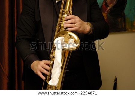 White musician playing the Saxophone in a live performance