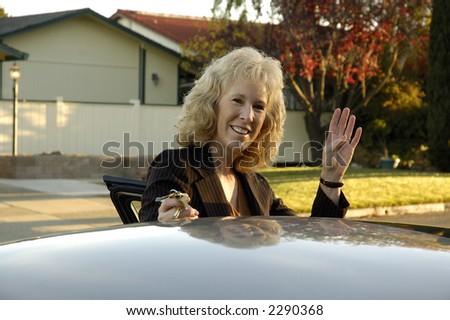 Business woman waving goodbye as she leaves for work in the morning