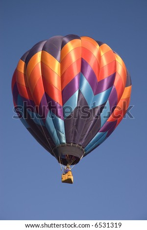 One of the many balloons at the Taos balloon festival rising in the cold morning air