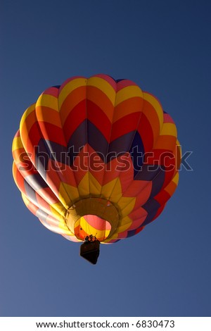 One of the many balloons at the Taos balloon festival rising in the cool mountain air