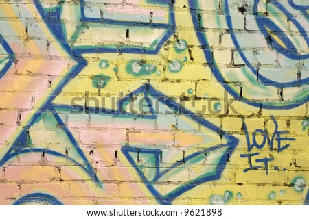 Graffiti on brick wall with arrow pointing to \