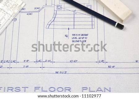 first floor plans of a house with pencil, eraser and slide rule