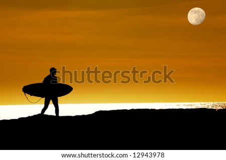 Surfer walking as the moon rises and the sun sets towards the pacific ocean along the cliffs in Santa Cruz to get that last ride