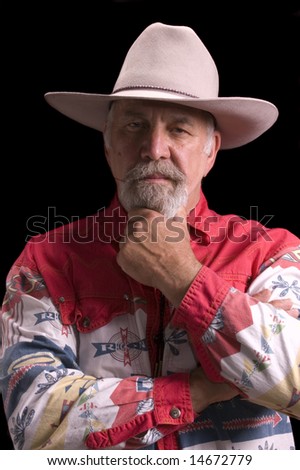 Handsome olld baby-boomer Cowboy dressed in black and looking like Buffalo Bill Cody