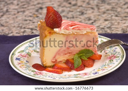 Plate of strawberry cheesecake with fresh strawberries