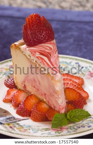 Plate of strawberry cheesecake with fresh strawberries
