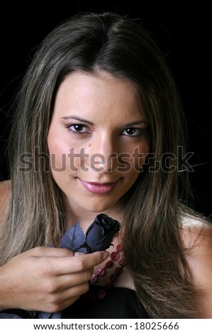 Beautiful young brunette woman with black rose