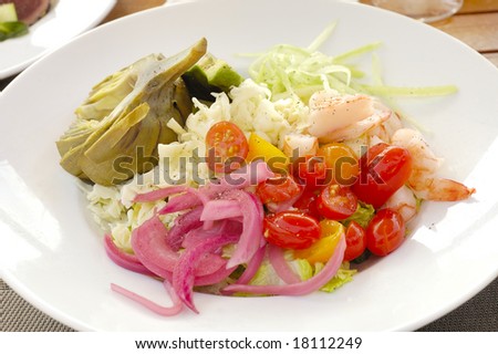 Shrimp and crab salad with tomato\'s, onion, artichoke, avocado, and chopped lettuce