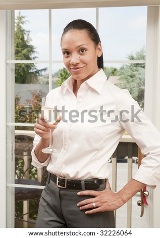 Beautiful african american woman smiling while drinking a glass of wine