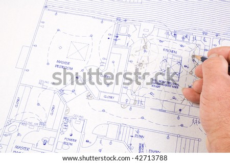 closeup of Architect making changes to house plans with pencil