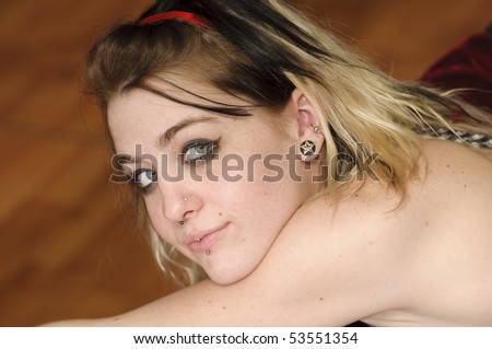 stock photo : Attractive female with a nose ring and lip piercing
