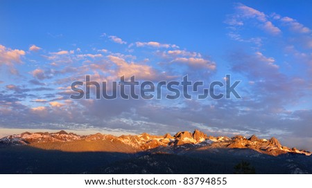 Golden glow of Dawn as the sun rises on the Minarets at Mammoth Lake, California