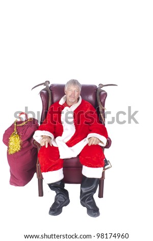 Humorous closeup of Santa Claus (that jolly old elf that  lives at the North Pole) resting after a hard nights work
