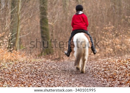 Young girl with a horse in a forest