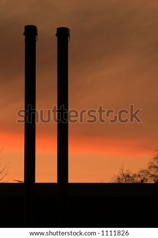 smoking chimney with a  warm orange sun