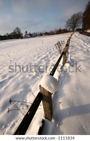 fence  under the snow  in  winter a sunny cold day